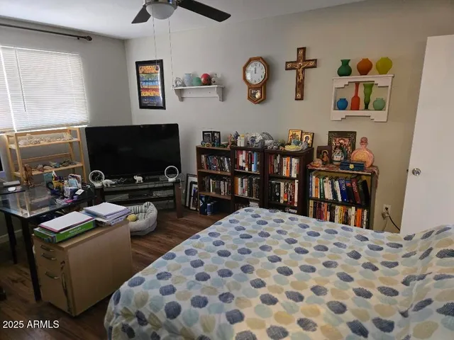 a bedroom with a bed and a flat screen tv