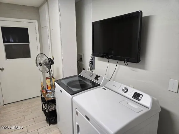 a kitchen with a stove and a flat screen tv