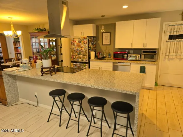 a kitchen with stainless steel appliances granite countertop a sink and cabinets