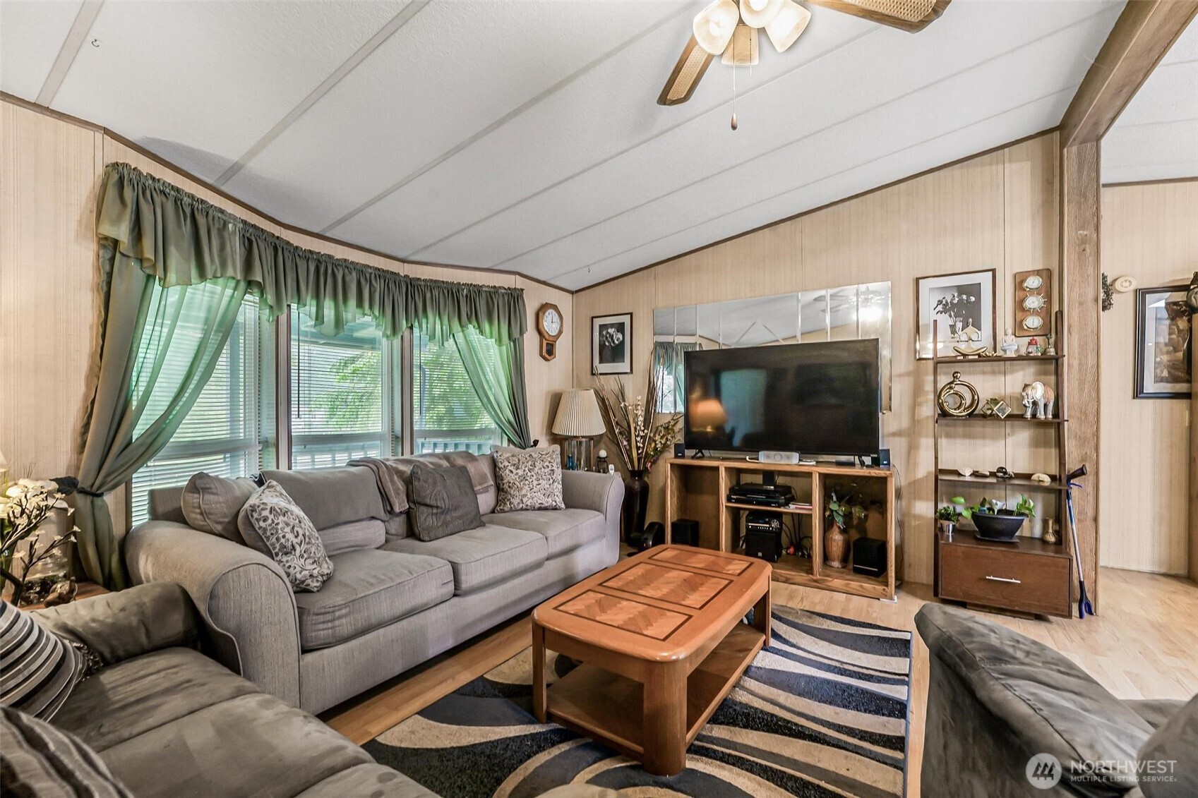 980 South Falcon Road Camano Island, WA 98282 - Photo 10 of 30 a living room with furniture a flat screen tv and a large window