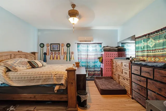 a bedroom with a bed and wooden floor