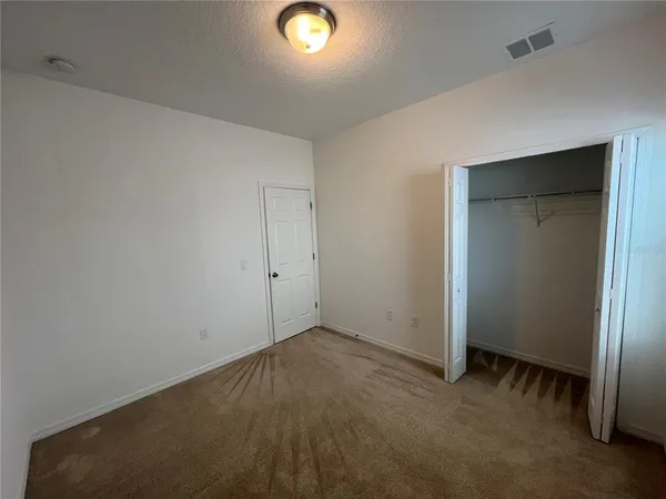 an empty room with closet area