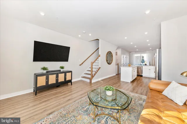 a kitchen with stainless steel appliances a stove microwave and refrigerator