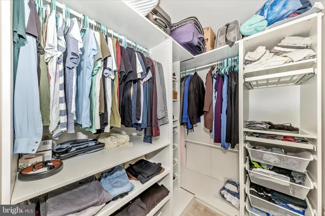 a view of a hallway with wooden floor and entryway