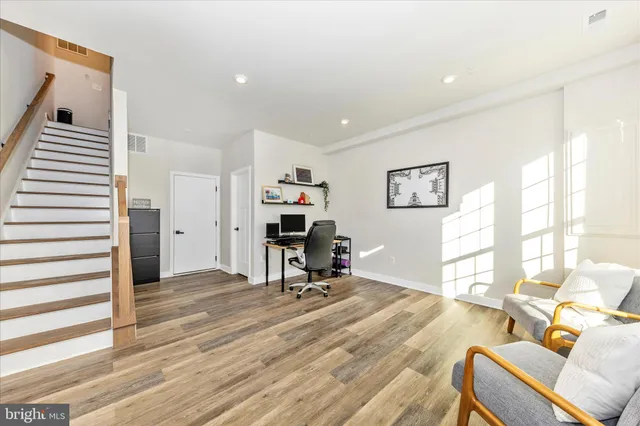 a view of a livingroom with workspace and a window