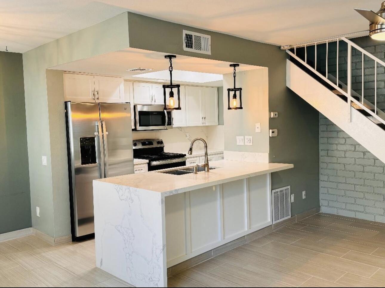 a kitchen with stainless steel appliances a refrigerator and a sink