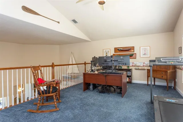 an aerial view of a house with garden space and street view