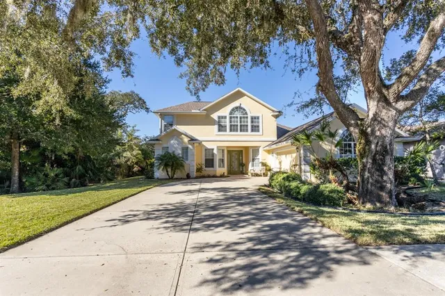 a kitchen with stainless steel appliances granite countertop a refrigerator a sink and a stove