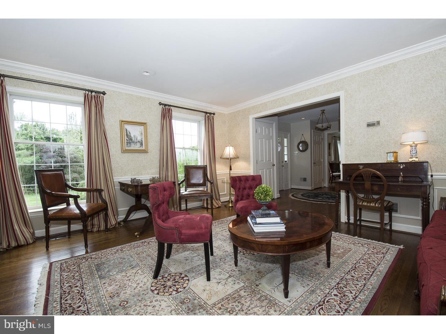 709 South Waterloo Road Devon, PA 19333 - Photo 3 of 25 a living room with furniture a rug a lamp and a window