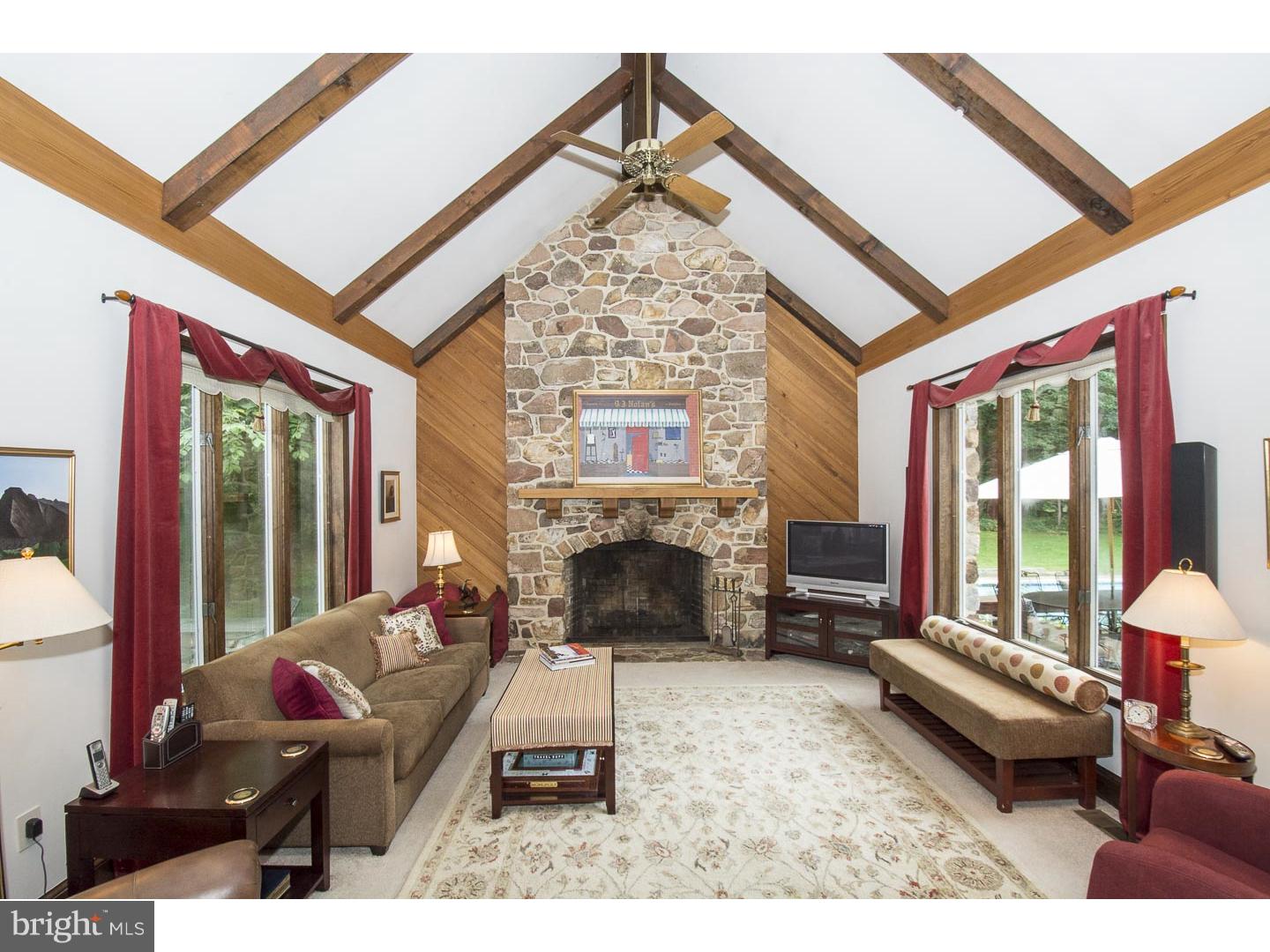 709 South Waterloo Road Devon, PA 19333 - Photo 5 of 25 a living room with furniture a fireplace and a large window