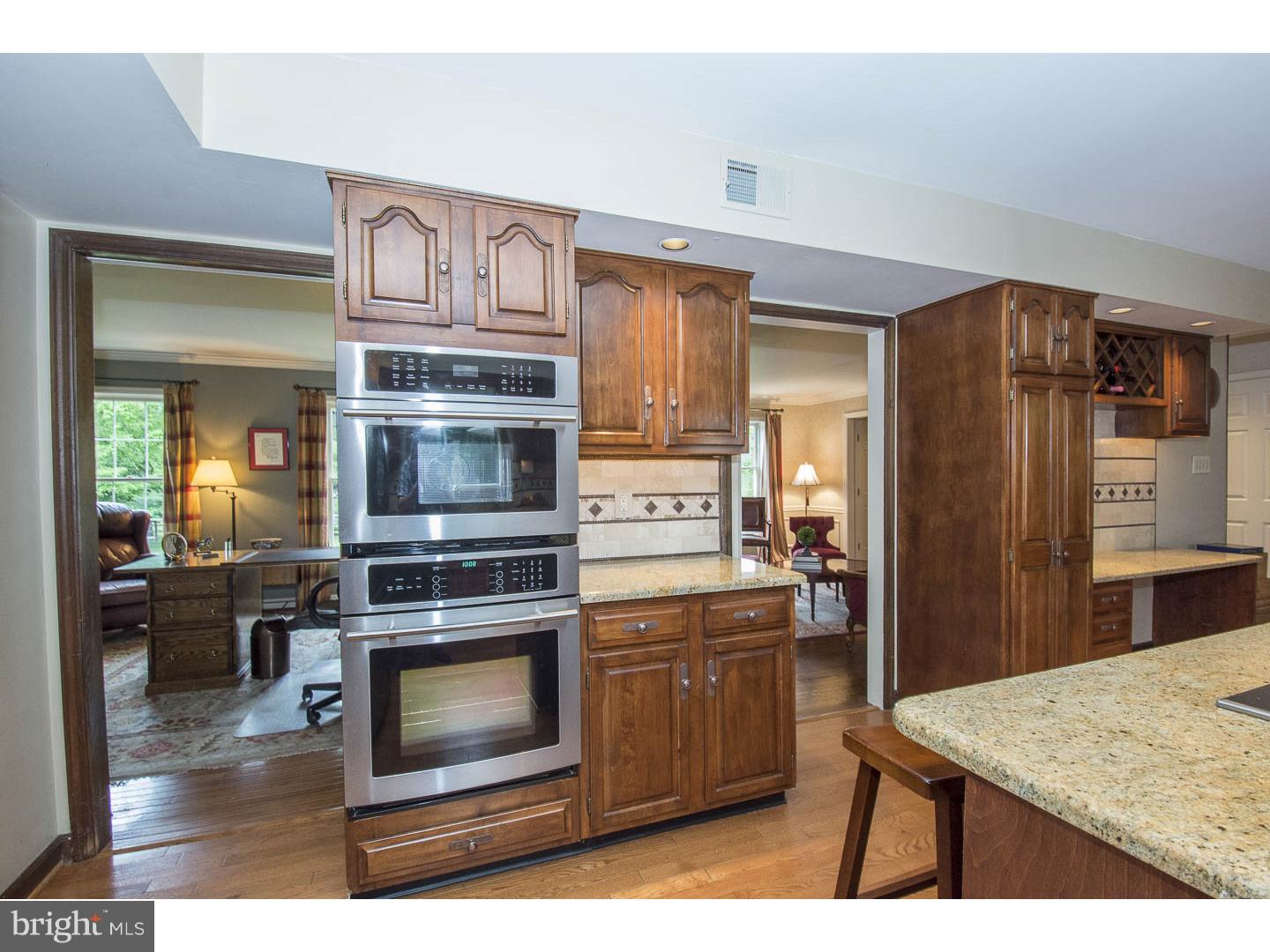 709 South Waterloo Road Devon, PA 19333 - Photo 8 of 25 a kitchen with stainless steel appliances kitchen island a stove a refrigerator and a sink