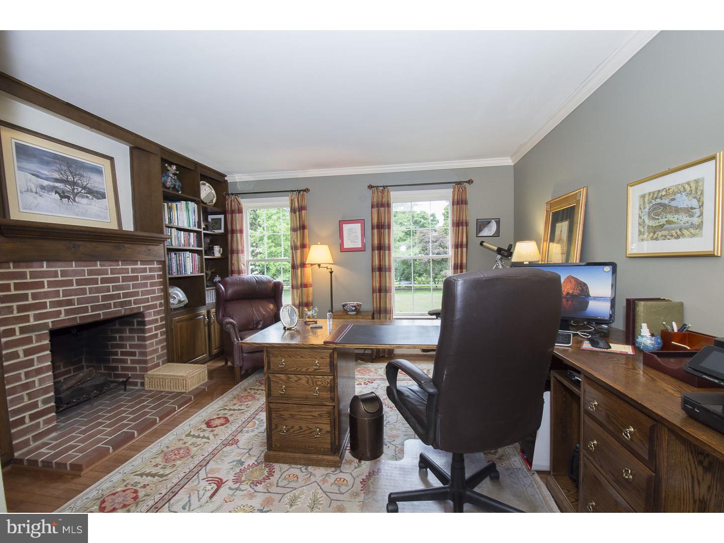 709 South Waterloo Road Devon, PA 19333 - Photo 10 of 25 a living room with furniture a fireplace and a large window