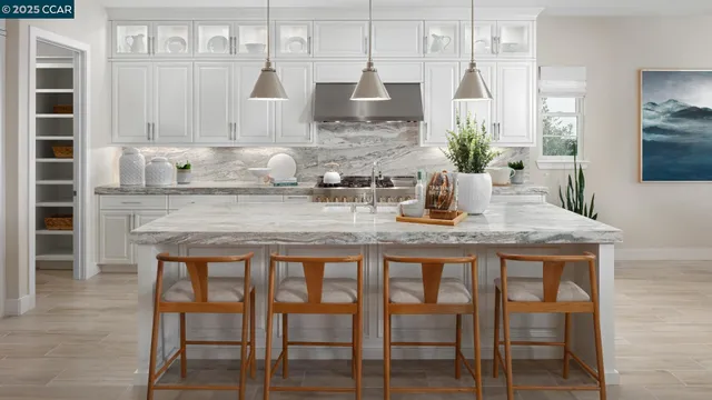 a kitchen with granite countertop white cabinets and stainless steel appliances