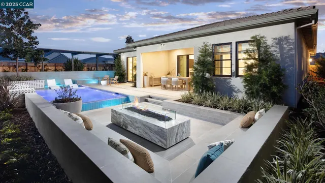 a view of a house with backyard and sitting area