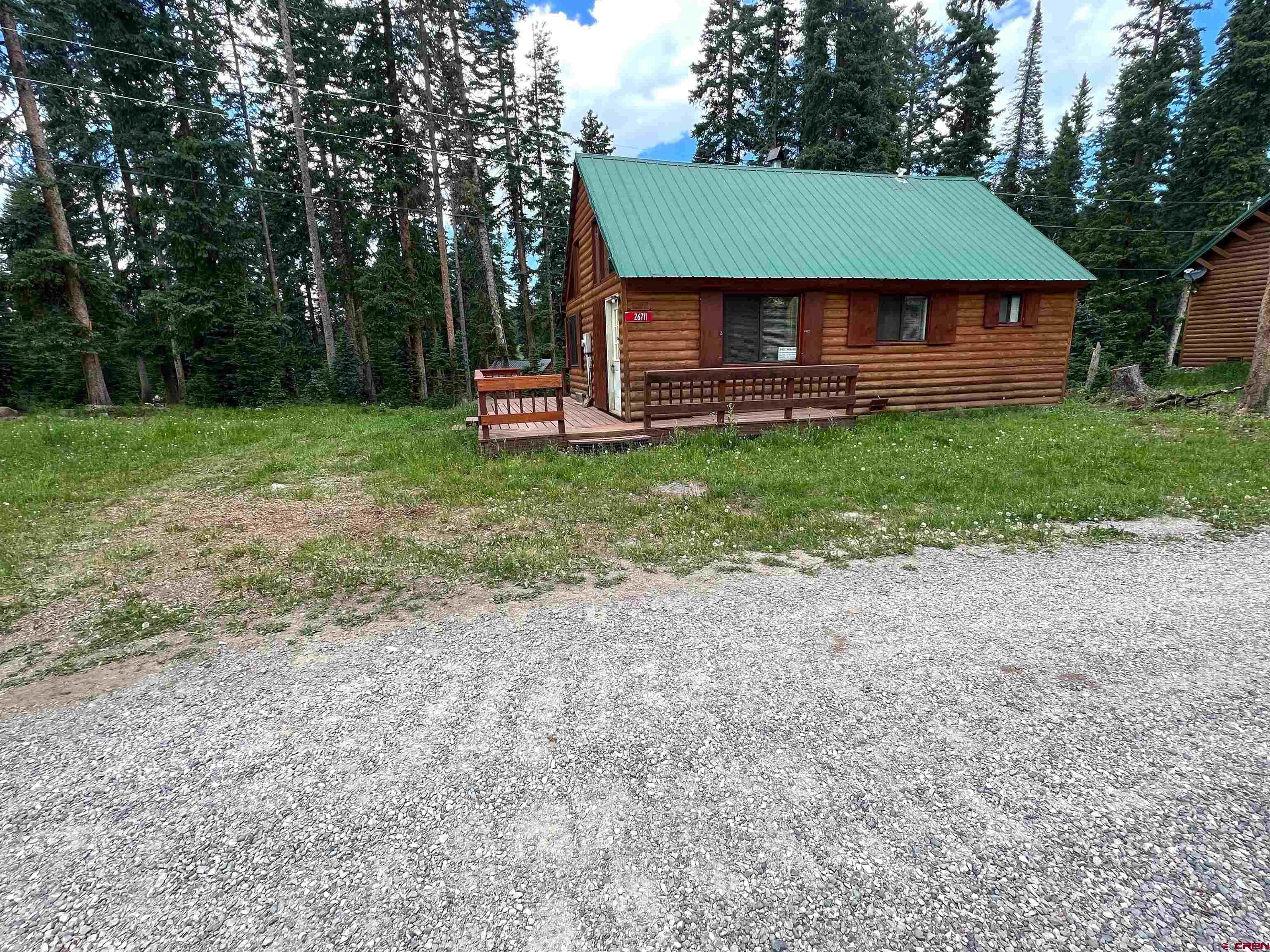 26711 High Drive Cedaredge, CO 81413 - Photo 3 of 9 a front view of a house with a garden and trees
