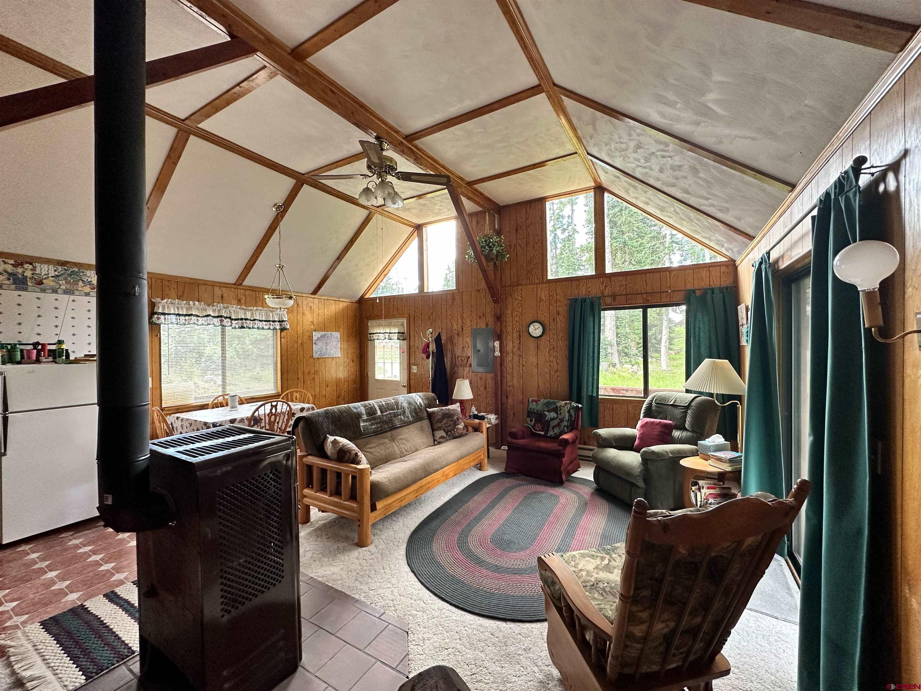 26711 High Drive Cedaredge, CO 81413 - Photo 5 of 9 a living room with furniture fireplace and a large window