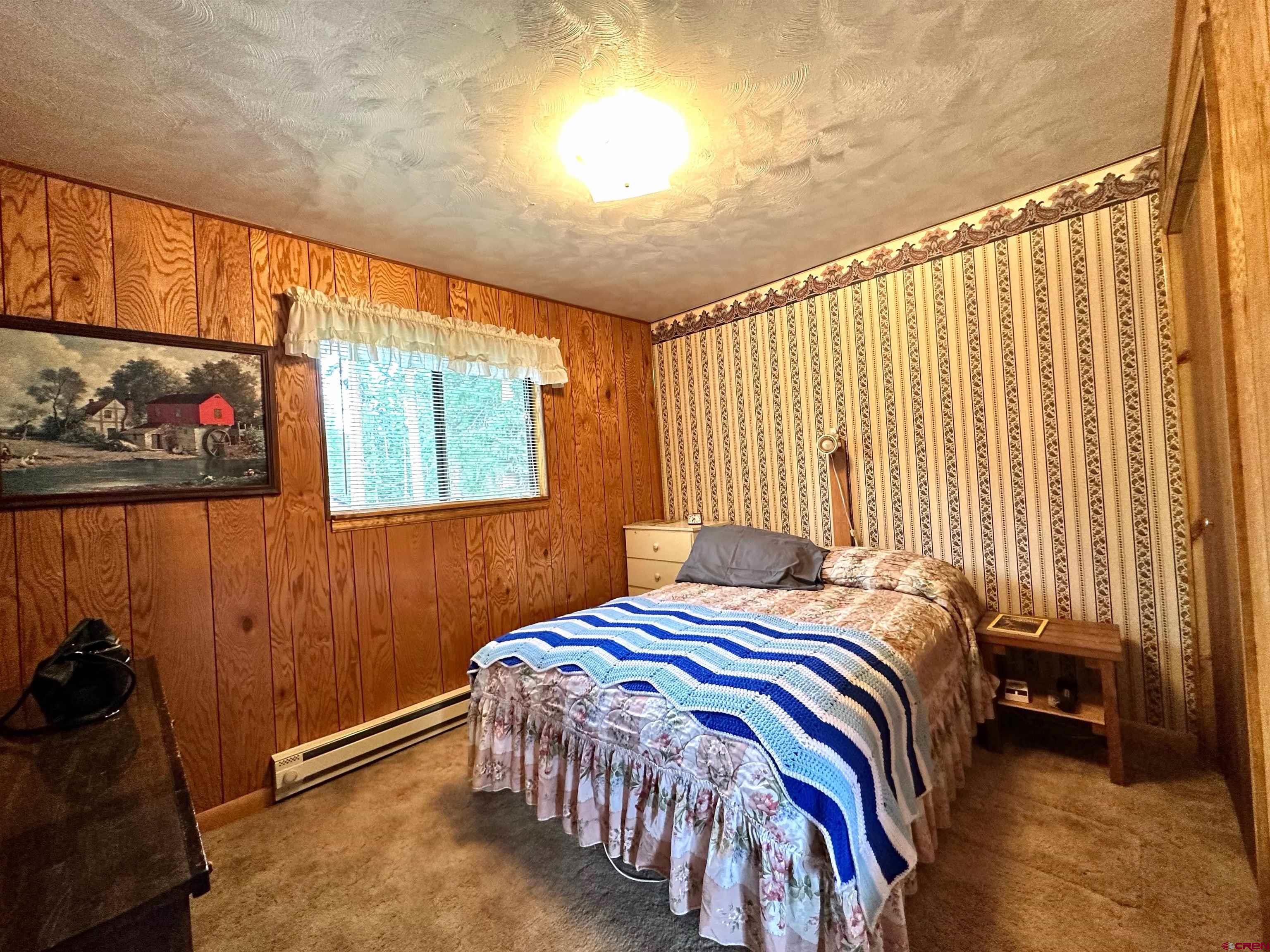 26711 High Drive Cedaredge, CO 81413 - Photo 7 of 9 a bedroom with a bed and a window