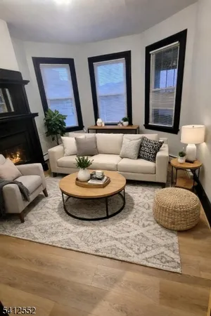 a living room with furniture and painting on the wall