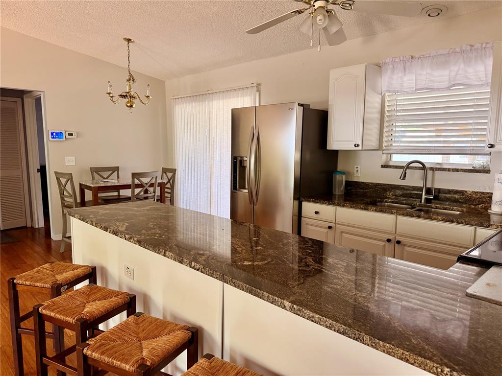 24521 Alligator Road Astor, FL 32102 - Photo 35 of 51 a kitchen with granite countertop a sink a counter top space appliances and cabinets
