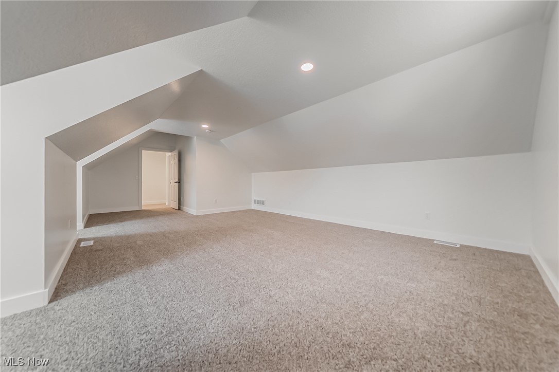 7488 Greenwich Road Seville, OH 44273 - Photo 23 of 37 Bonus room featuring vaulted ceiling, light carpet, and recessed lighting