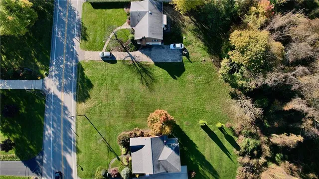 an aerial view of a residential houses with outdoor space