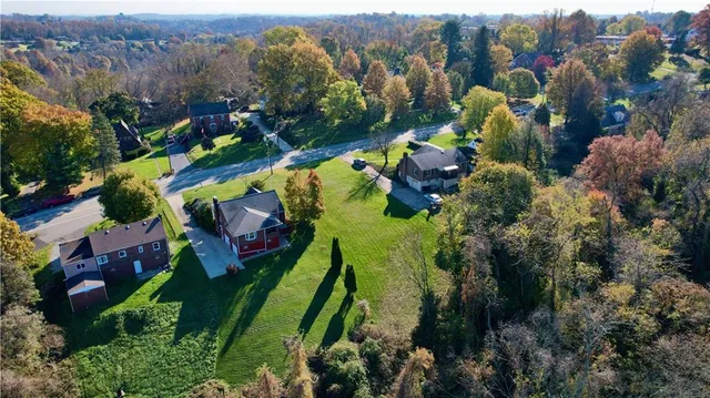 an aerial view of swimming pool yard and mountain view in back
