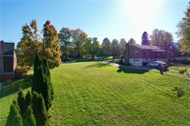 a view of a house with a yard and a fountain