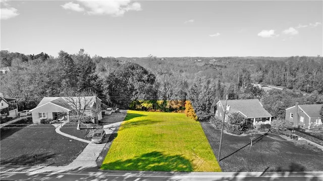 a view of a swimming pool with outdoor seating and covered with green space
