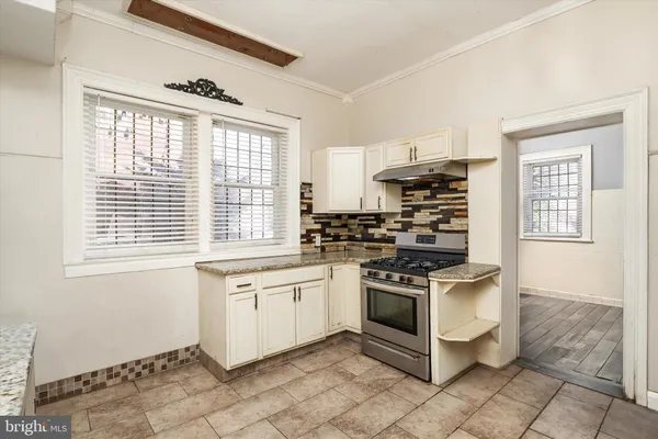 a kitchen with stainless steel appliances granite countertop a stove a refrigerator and a microwave