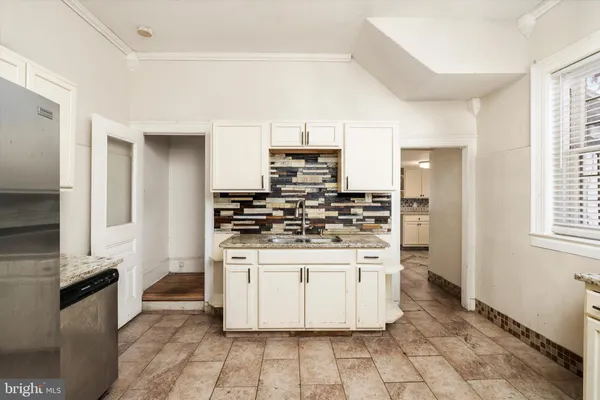 a kitchen with stainless steel appliances granite countertop a stove and a refrigerator