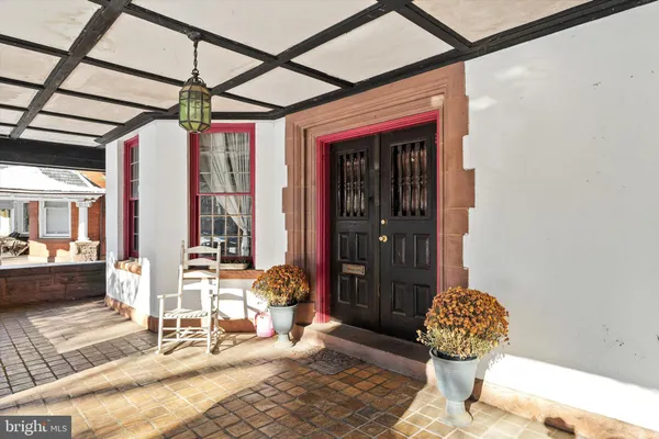 a front view of a house with outdoor seating