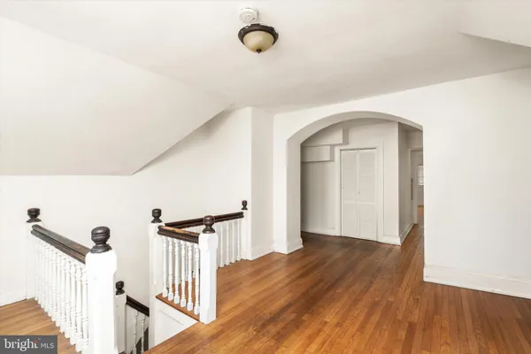 a view of a room with wooden floor and windows