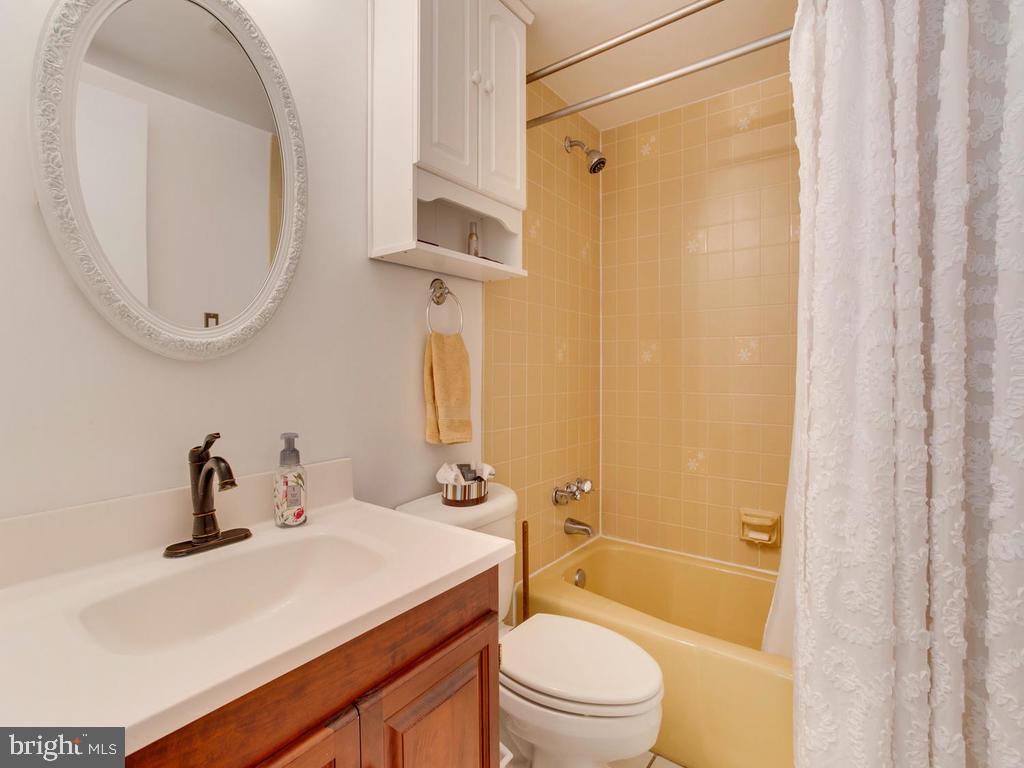 6678 Old Solomons Island Road Friendship, MD 20758 - Photo 43 of 57 a bathroom with a sink a toilet and shower