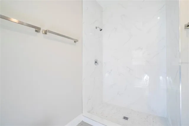 an empty room with wooden floor & closet area