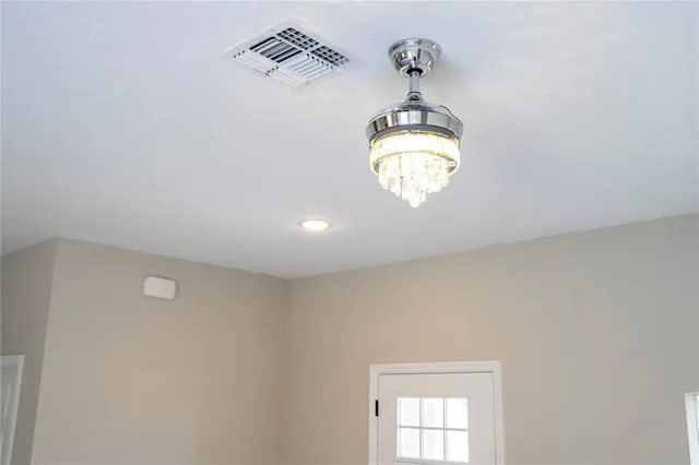 an aerial view of a house with a yard big trees