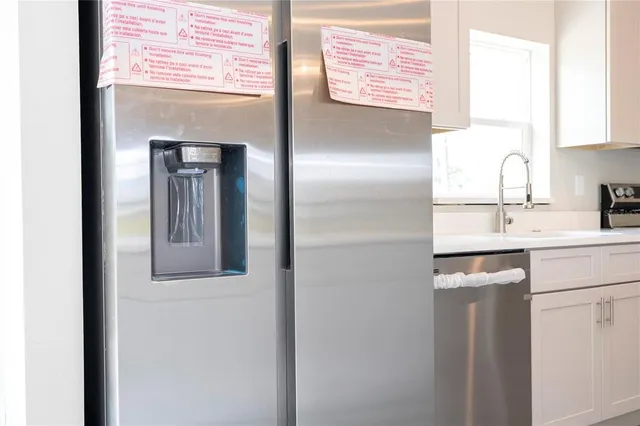 a kitchen with a refrigerator and sink