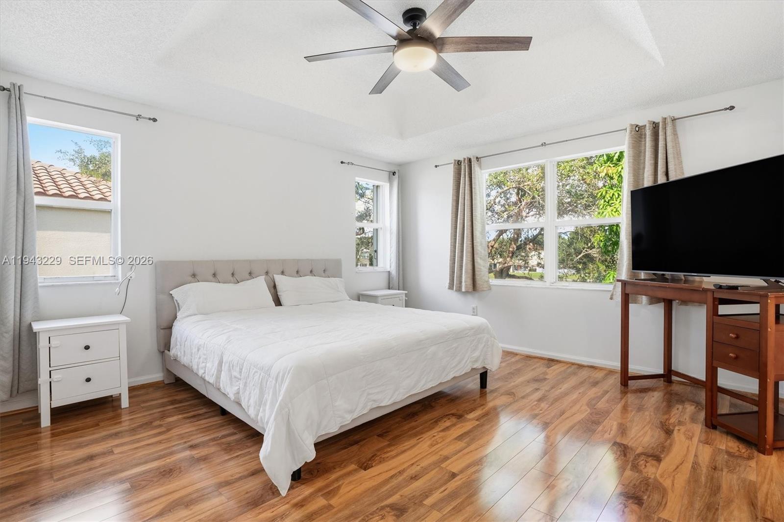 16367 Southwest 48th Street Miramar, FL 33027 - Photo 13 of 41 a bedroom with a bed and a flat screen tv