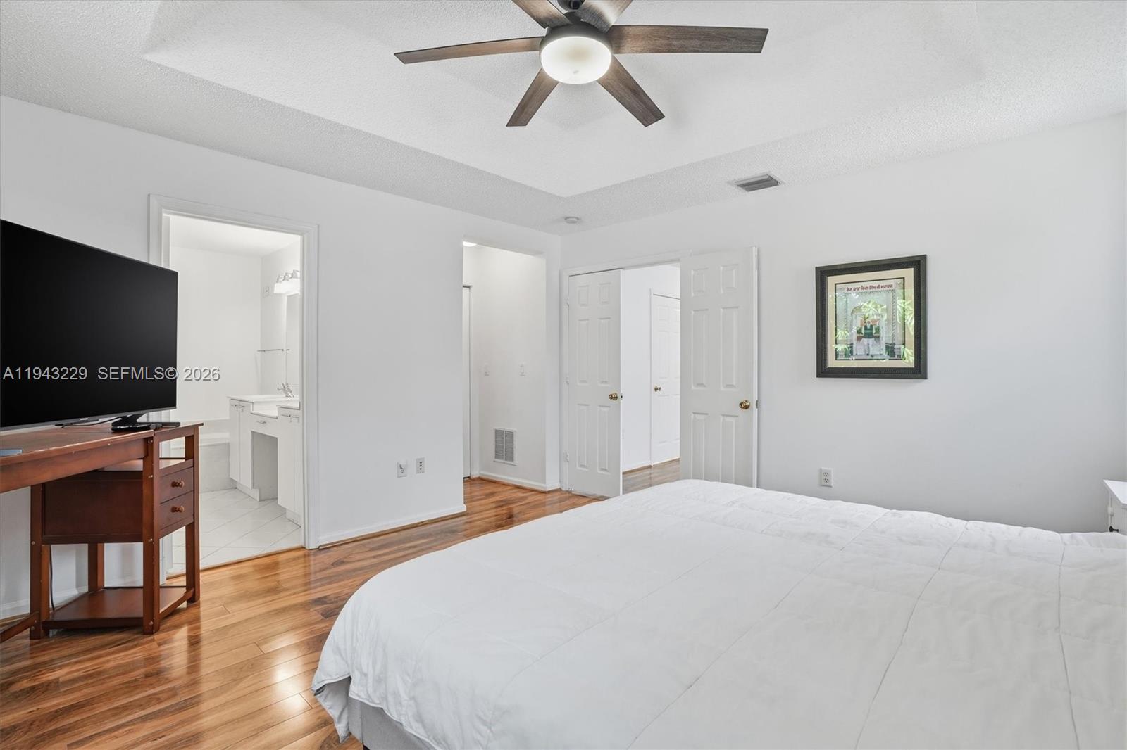 16367 Southwest 48th Street Miramar, FL 33027 - Photo 14 of 41 a bedroom with a bed and a flat screen tv