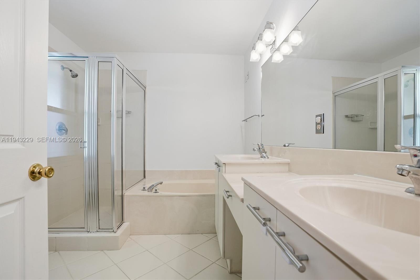 16367 Southwest 48th Street Miramar, FL 33027 - Photo 15 of 41 a bathroom with a tub a sink and mirror