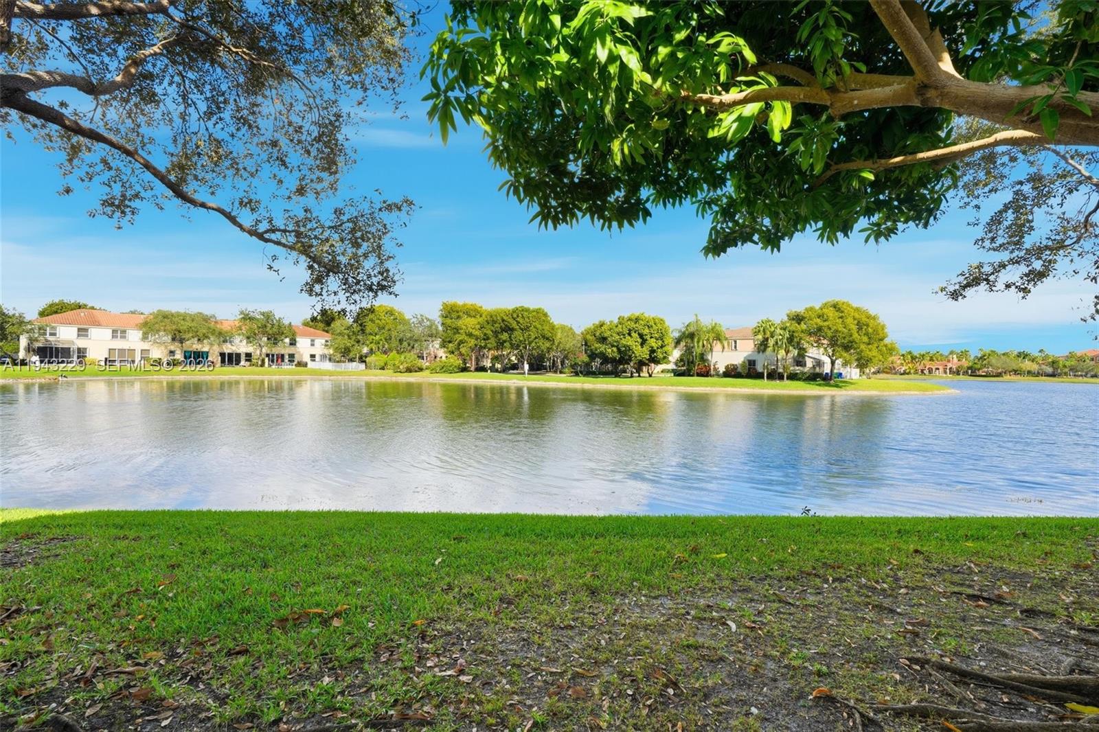 16367 Southwest 48th Street Miramar, FL 33027 - Photo 27 of 41 a view of a lake with houses in the back