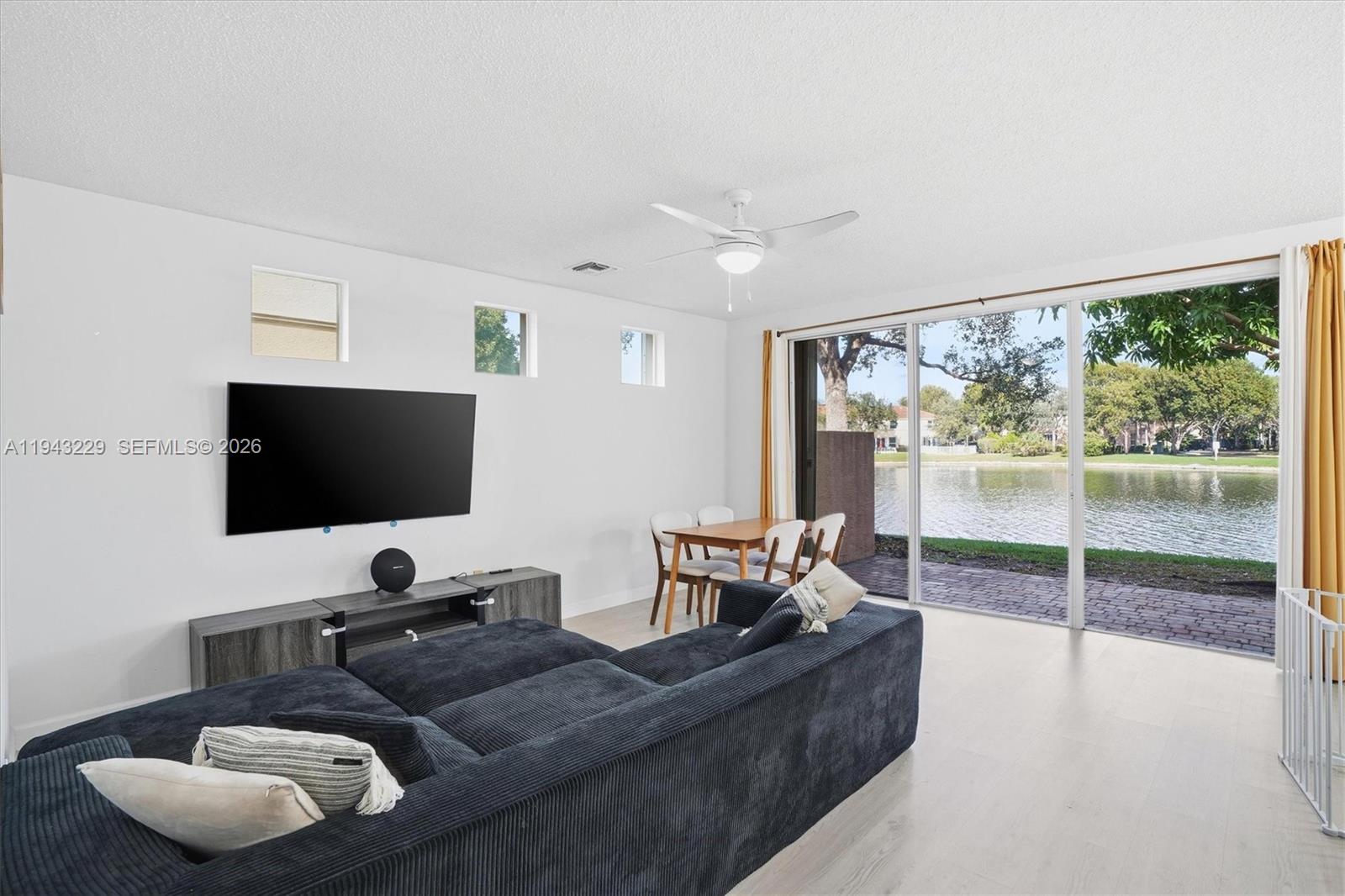 16367 Southwest 48th Street Miramar, FL 33027 - Photo 4 of 41 a living room with furniture and a flat screen tv