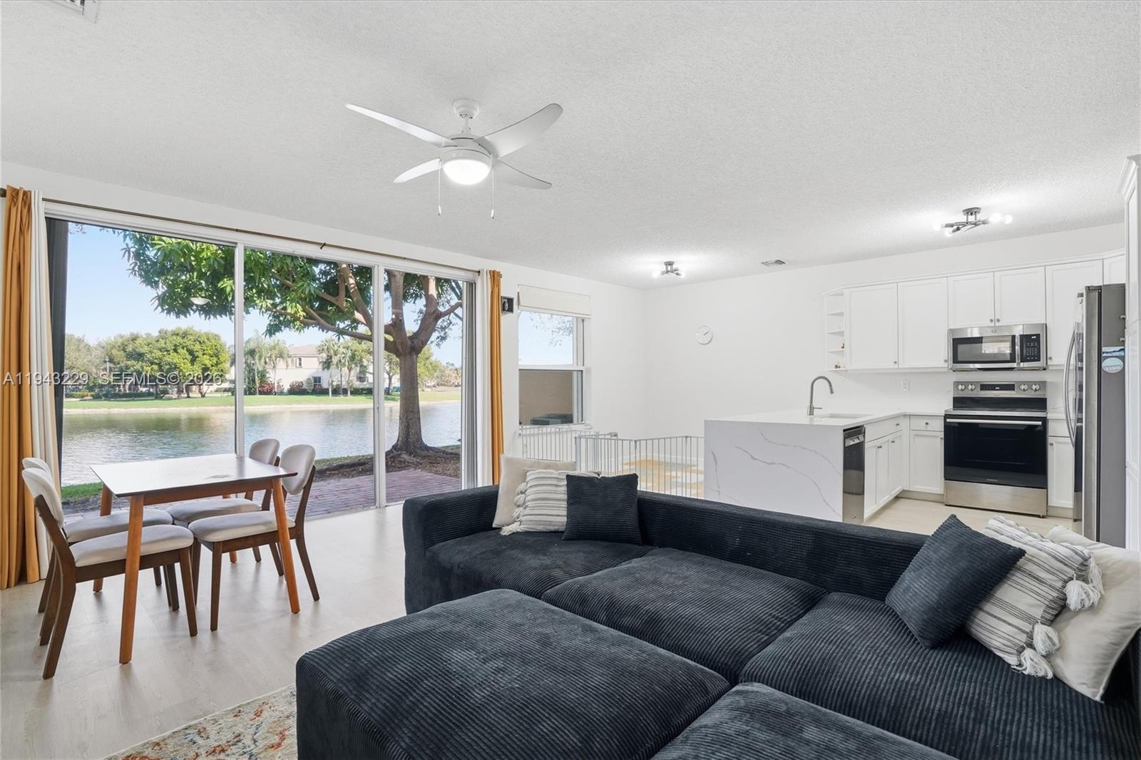 16367 Southwest 48th Street Miramar, FL 33027 - Photo 6 of 41 a living room with furniture and a large window