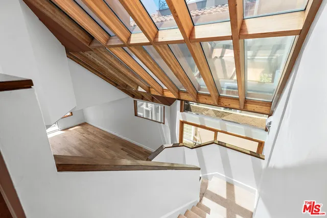 a spacious bedroom with a bed and cabinet