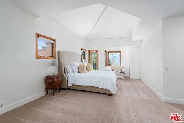 a bedroom with a large bed and a couch