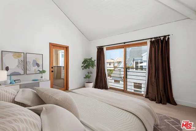 a bathroom with a granite countertop sink toilet mirror and a shower