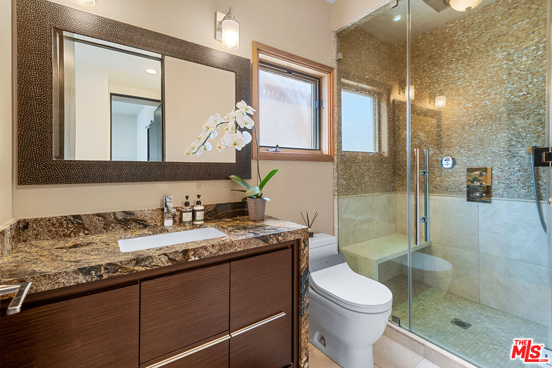 117 Ketch Mall Marina del Rey, CA 90292 - Photo 20 of 43 a bathroom with a granite countertop sink toilet mirror and a shower