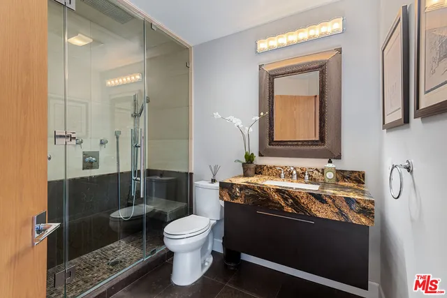 a front view of multi story residential apartment building with yard and green space