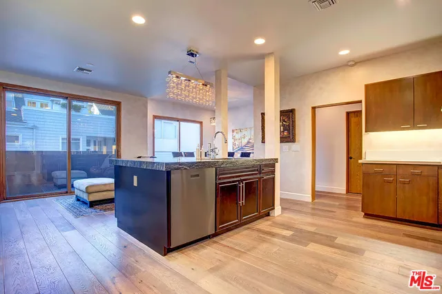 a kitchen with stainless steel appliances granite countertop a stove and a refrigerator