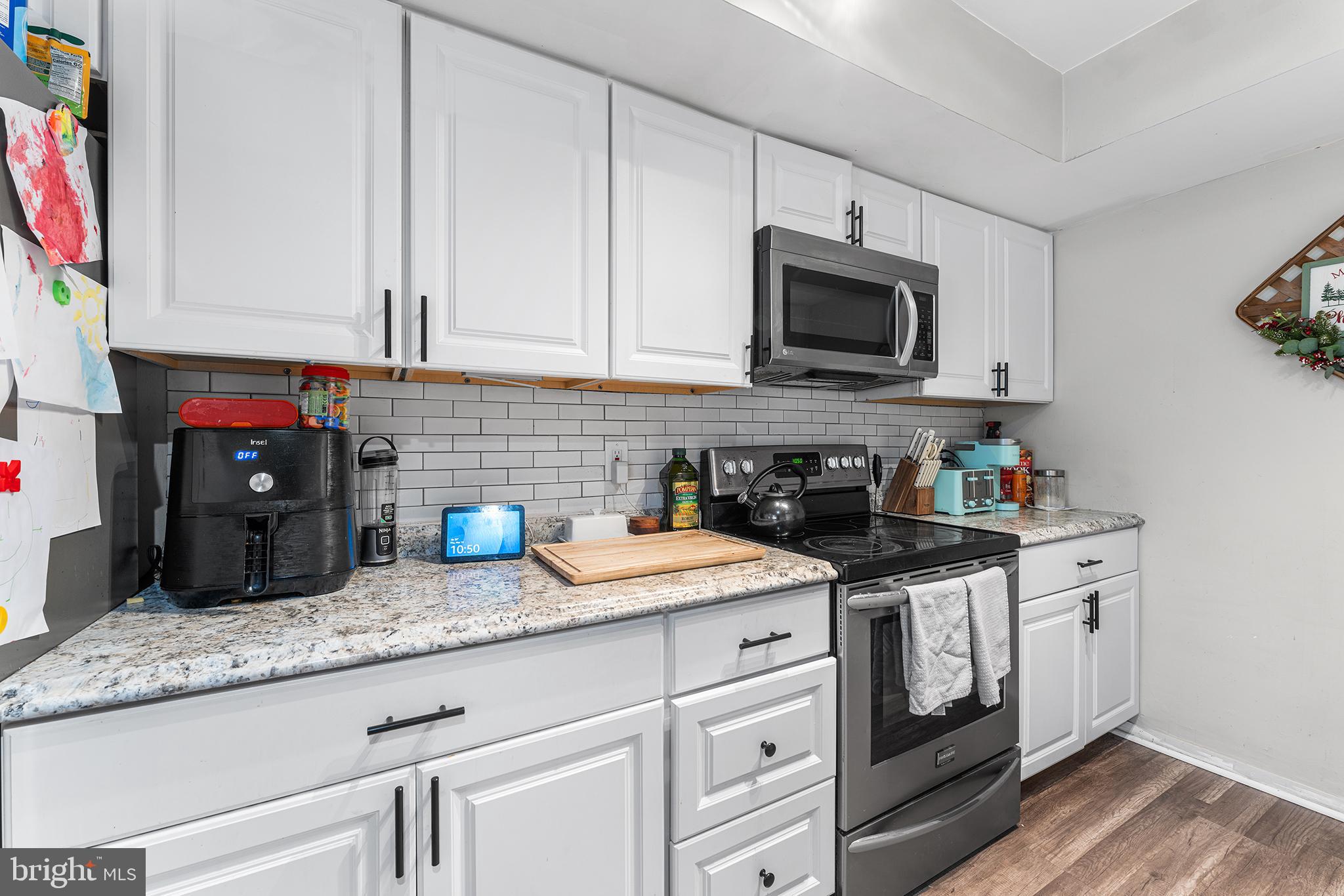 115 East Kings Highway, Unit 186 Maple Shade, NJ 08052 - Photo 11 of 25 a kitchen with granite countertop a sink a stove and cabinets