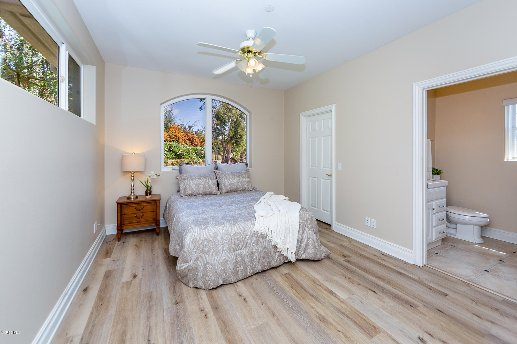 10089 Stockton Road Moorpark, CA 93021 - Photo 14 of 39 a bedroom with a bed and a chandelier